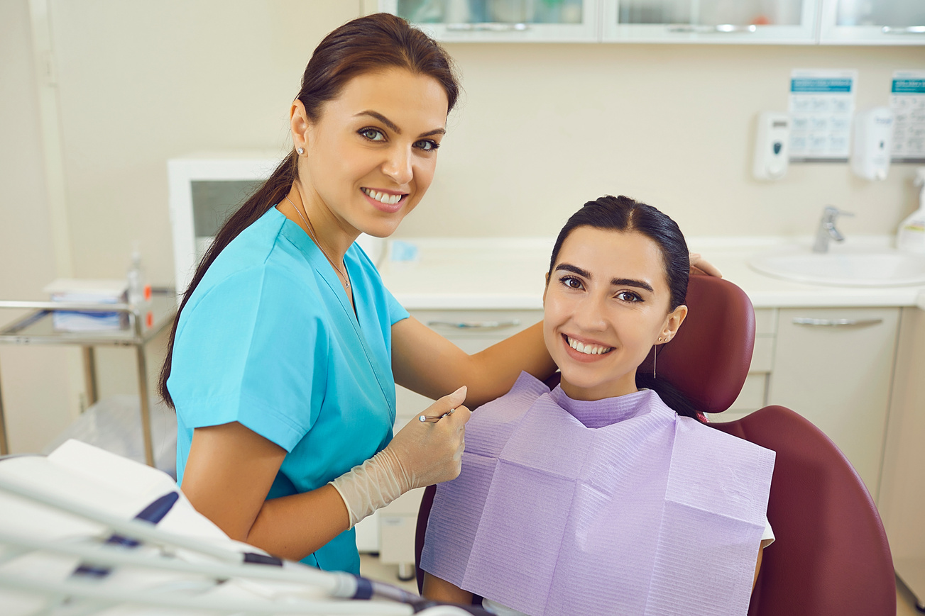 Dentist and Woman Patient Smiling during Teeth Examination in Dentist Office