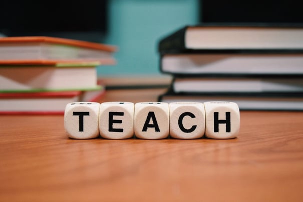 Word Teach Written with Dices on a Desk